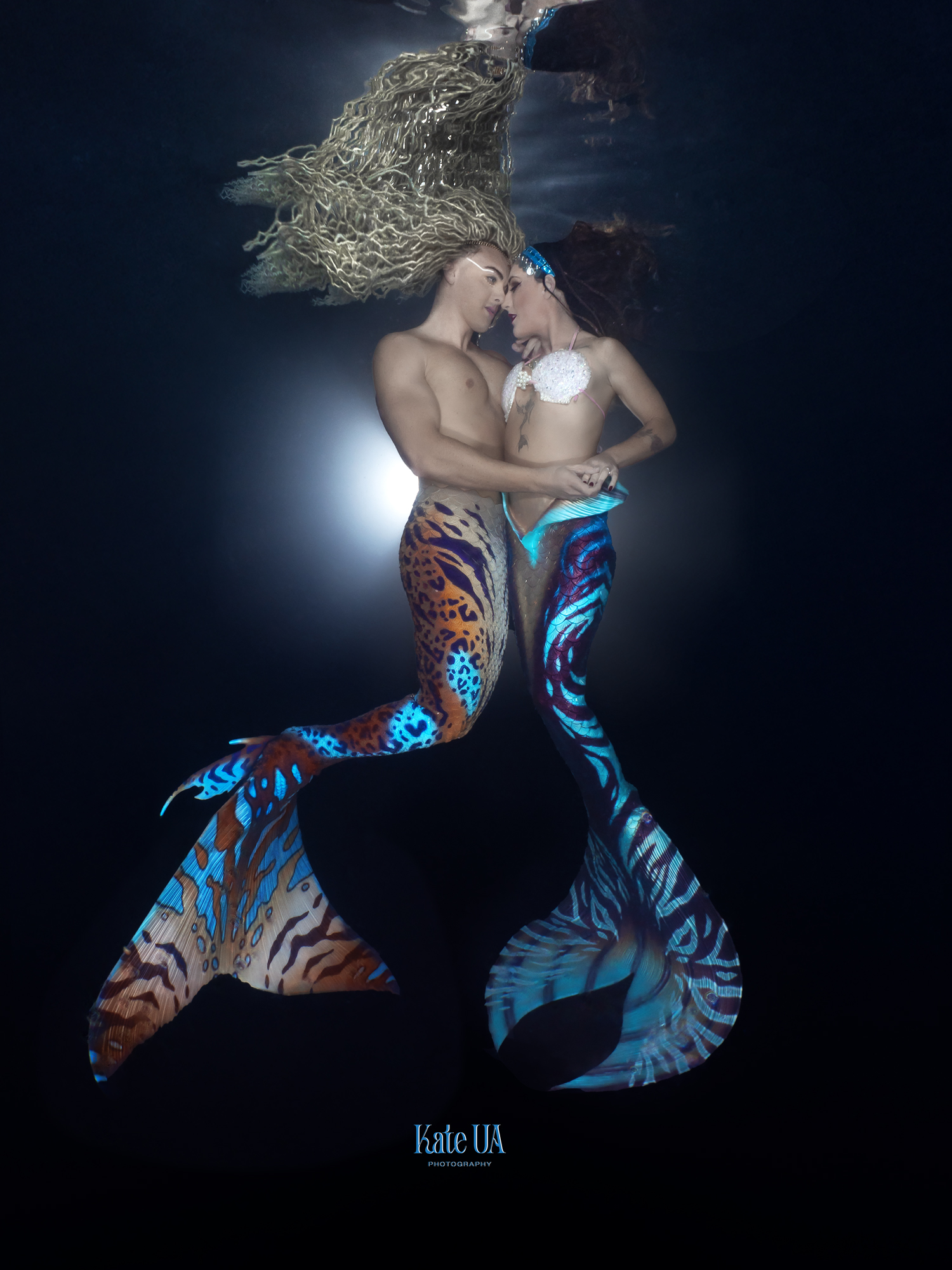 The Prince and Heather Mermaid embracing underwater